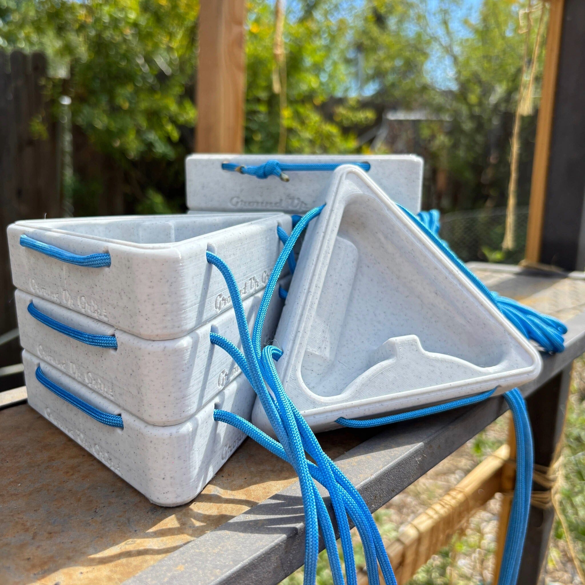 Stack of triangular warm up blocks sitting on a metal surface with a natural background