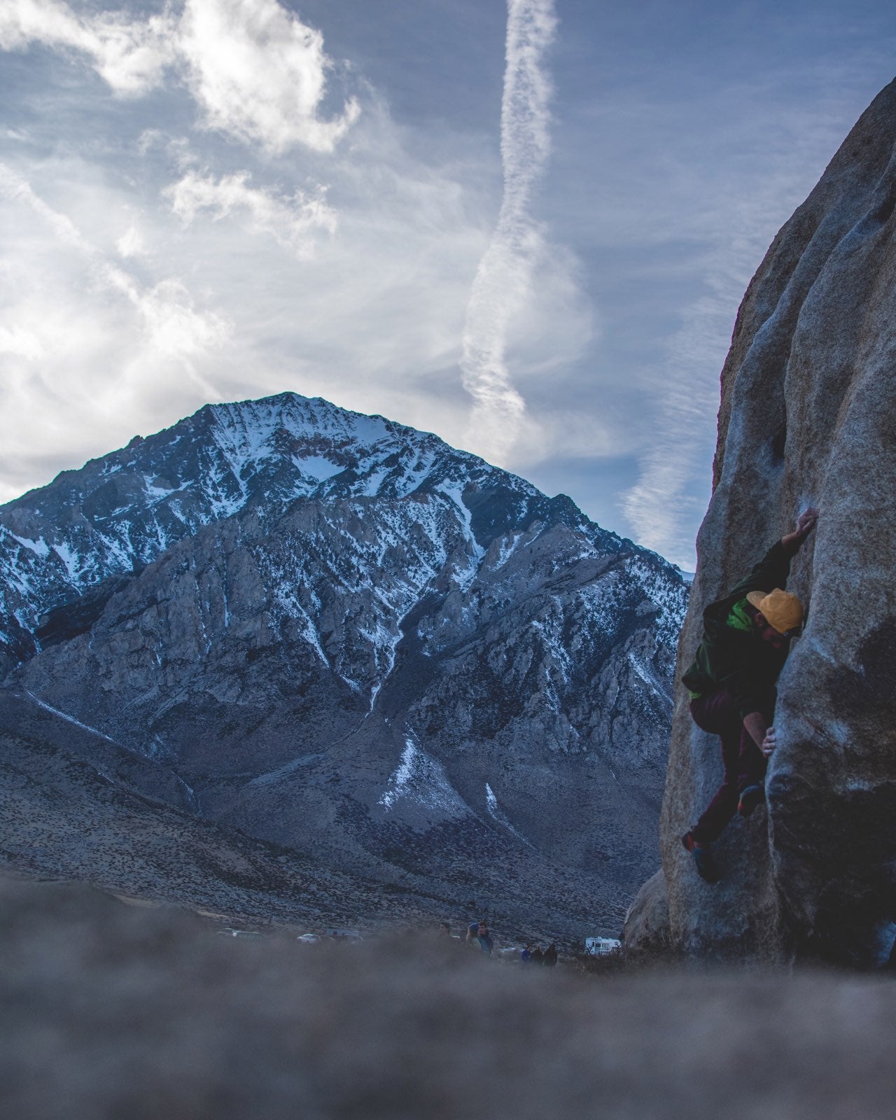Boulderer in a shallow dihedral with the Eastern Sierra looming in the background