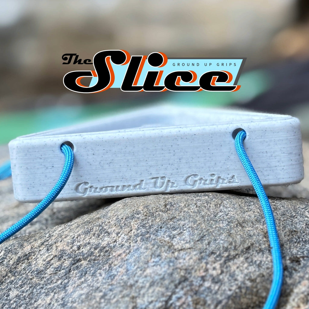 Warm up block with blue strings on a rock, featuring 'The Slice' brand logo.